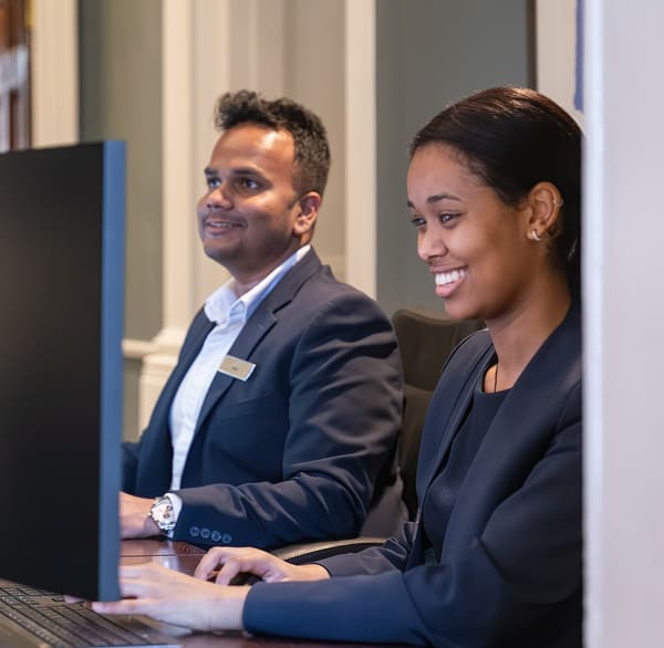 Two Argyll employees working and smiling together