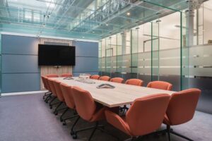 Woodcroft meting room with glass walls, refreshments and tv